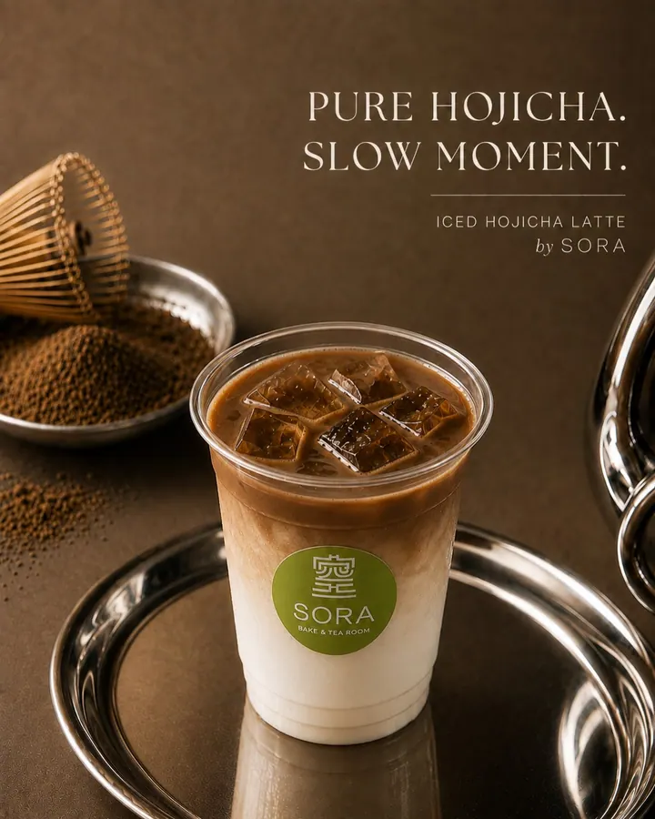 Iced hojicha latte with Sora logo, hojicha powder, and bamboo whisk