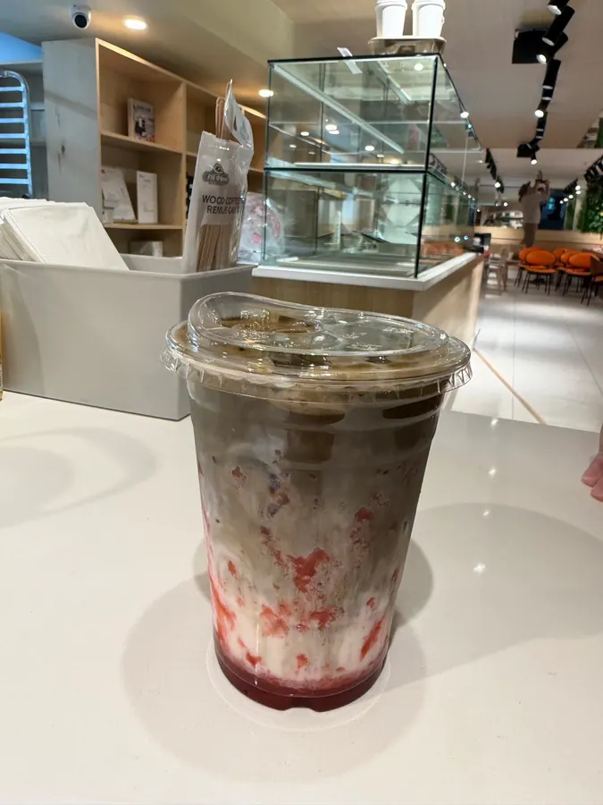 Iced strawberry hojicha latte on the counter at Sora